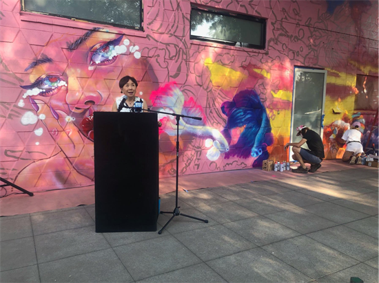 Congresswoman Matsui speaks in front of a mural.