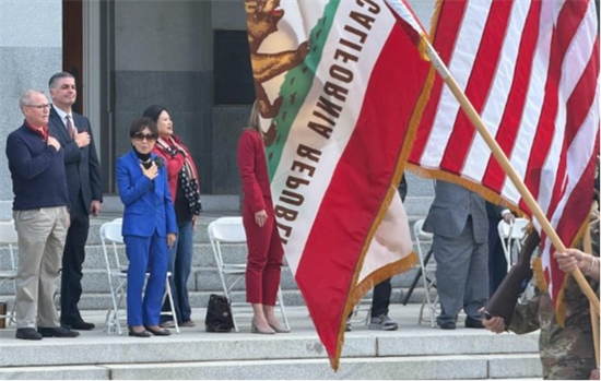 Doris puts her hand over her heart as JROTC passes.